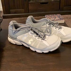 Under Armour white and grey running shoes.